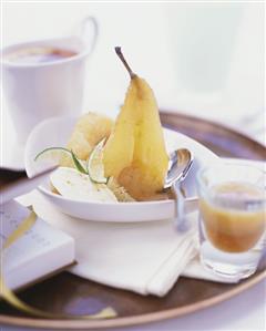 Poached pear with ice cream and lime wedges