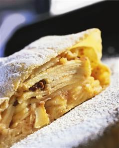 Piece of apple strudel with icing sugar