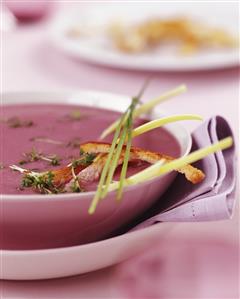 Red onion soup with cress and strips of bread