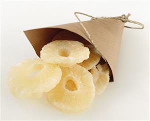 Candied pineapple slices in paper bag