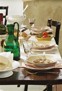 Laid table with tomato soup (Tuscany, Italy)