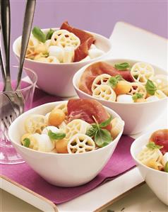 Colourful pasta salad with ham, melon and mozzarella