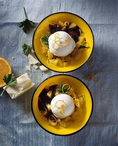 Soya yoghurt ice cream on oranges with scented geranium leaves