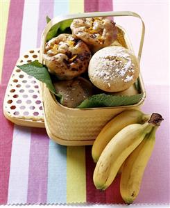 Banana muffins and chocolate & mango muffins in basket, bananas