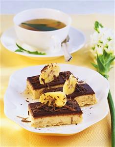 Banana slices with chocolate icing, cup of tea