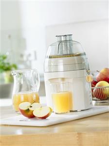 Freshly pressed apple juice with electric juicer