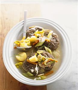 Cooked slices of beef leg with soup vegetables & potatoes