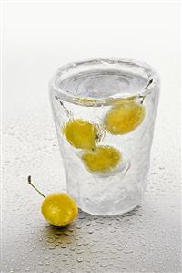 Ice glass with schnapps and mirabelles