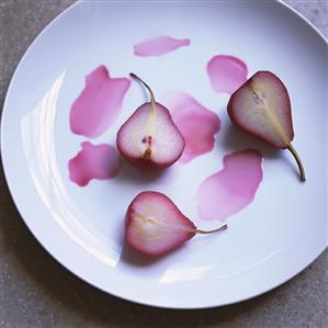 Poached pears with red wine sauce on plate