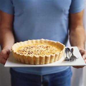 Person serving caramelised lemon tart