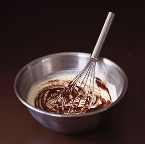 Mixing melted chocolate with cream