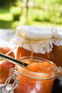 Nectarine jam in jars on table in the open air