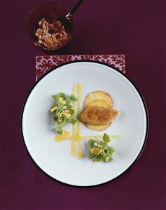 Marinated goose liver on apples, garnished with corn salad