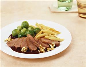 Duck breast with chocolate sauce and gold leaf