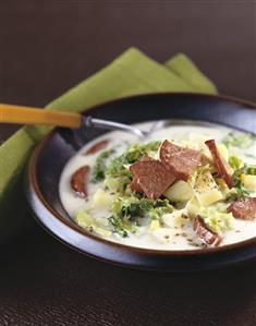 Potato and cabbage soup with slices of sausage