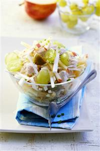 Poultry salad with fruit in glass bowl