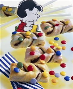 Puff pastry twists with coloured chocolate beans for children