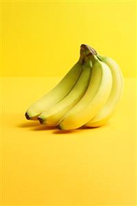 Bunch of bananas on yellow background