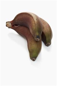 Red bananas on white background