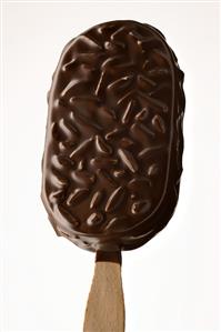 Chocolate-coated ice cream with almonds on a stick