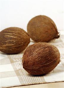 Three coconuts on tea towel