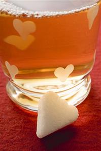 Glass of winter tea with sugar lump for Valentine's Day