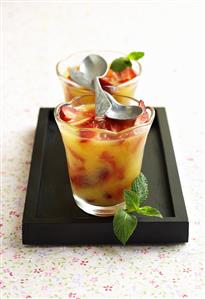 Grapefruit jelly with strawberries in two glasses