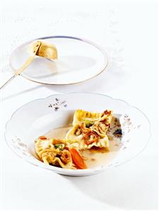 Ravioli with meat filling in clear soup