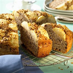 Warm apple cake, cut into pieces, on cake rack