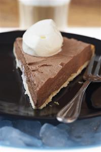 Piece of frozen chocolate pie with cream