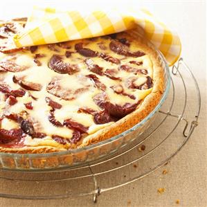 Plum tart on cake rack