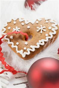 Gingerbread heart surrounded by Christmas decorations