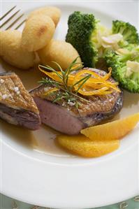 Duck breast with orange, potato croquettes and broccoli