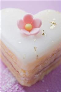 Small heart-shaped cake with sugar flower and gold leaf
