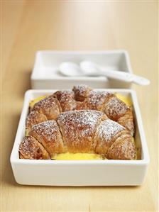 Two chocolate croissants in custard