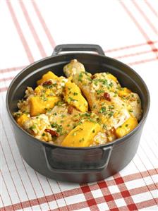 Chicken with mango in a cast-iron pot