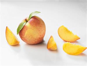 Whole peach and peach wedges