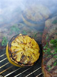 Grilled lemons and chops on a barbecue rack