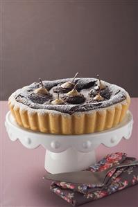 Pear and chocolate tart on cake stand