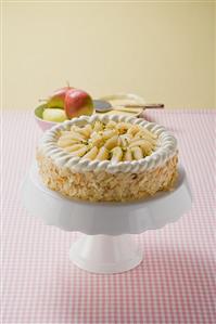 Pear cake with flaked almonds on cake stand