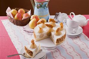 Pear yoghurt cheesecake on cake stand, tea things