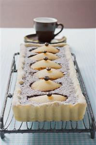 Pear and chocolate tart with mocha beans, espresso cup