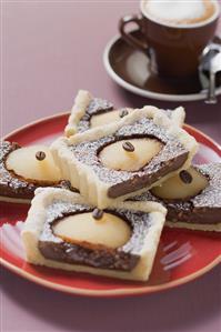 Several pieces of pear and chocolate tart and cappuccino