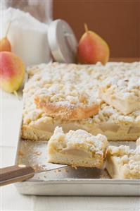 Pear crumble cake on baking tray (detail)