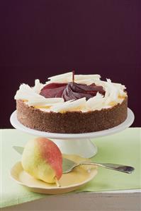 Cheesecake with red wine pears and white chocolate curls