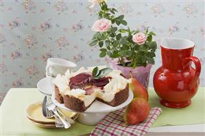 Cheesecake with red wine pears and white chocolate curls