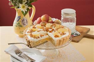 Apple tart with cream and nut brittle, a piece cut