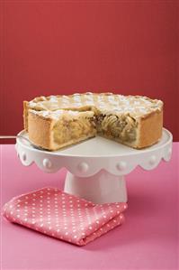 Apple pie, a piece cut, on cake stand