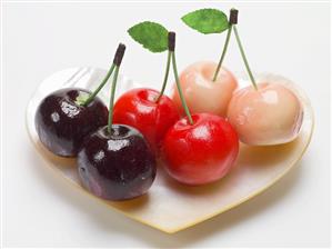 Marzipan cherries in heart-shaped mother-of-pearl dish