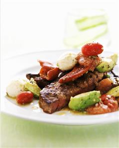 Grilled steak with vegetables, mozzarella and grapefruit